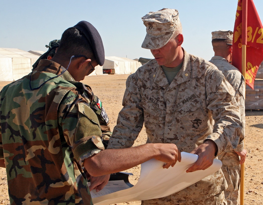 Maj. Christopher Wills, commanding officer of Kilo Company, Battalion Landing Team, 3rd Battalion, 2nd Marine Regiment, 22nd Marine Expeditionary Unit, presents battle maps of Iwo Jima to a Jordanian commando during Exercise Bright Star 2009 in Egypt, Oct. 13, 2009. The multinational exercise is designed to improve readiness, interoperability, and strengthen the military and professional relationships among U.S., Egyptian and participating forces. Bright Star is conducted by U.S. Central Command and held every two years. Elements of the 22nd MEU are currently are participating in the multi-national exercise while serving as the theater reserve force for U.S. Central Command.::r::::n::(Official Marine Corps Photo by Lance Cpl. David Castillo)::r::::n::