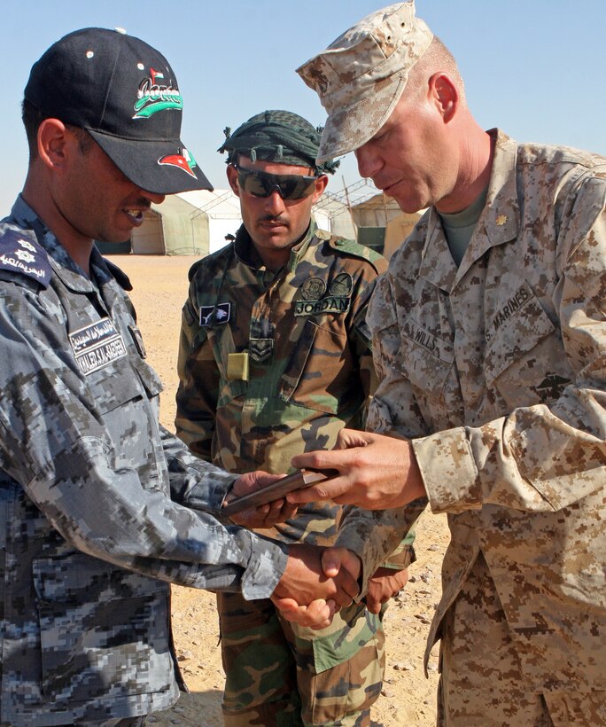 Maj. Christopher Wills, commanding officer of Kilo Company, Battalion Landing Team, 3rd Battalion, 2nd Marine Regiment, 22nd Marine Expeditionary Unit, presents a to a Jordanian commando during Exercise Bright Star 2009 in Egypt, Oct. 13, 2009. The multinational exercise is designed to improve readiness, interoperability, and strengthen the military and professional relationships among U.S., Egyptian and participating forces. Bright Star is conducted by U.S. Central Command and held every two years. Elements of the 22nd MEU are currently are participating in the multi-national exercise while serving as the theater reserve force for U.S. Central Command.::r::::n::(Official Marine Corps Photo by Lance Cpl. David Castillo)::r::::n::