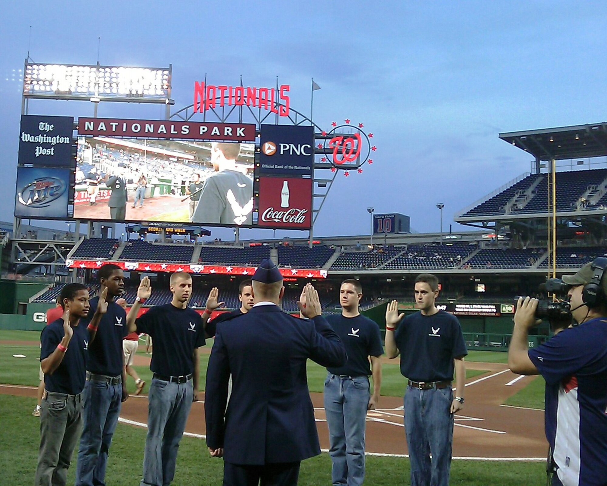 Lt. Col. John Feather, 317th Recruiting Squadron commander, performs a pre-game enlistment ceremony during “Air Force Night” at the Washington Nationals ball park Sept. 24. Members of the Delayed Enlistment Program were able to participate in pre-game activities with the players and managers. Additionally, the evening's events included Air Force static displays, the Air Force Honor Guard, an Air Force band vocalist, and a guest appearance by Ricky the Recruiter. The Air Force participates in community events and corporate sponsorships to showcase the Air Force and help meet the Air Force recruiting mission of recruiting quality men and women. (U.S. Air Force photo/Tech. Sgt. Stephen Sutton)