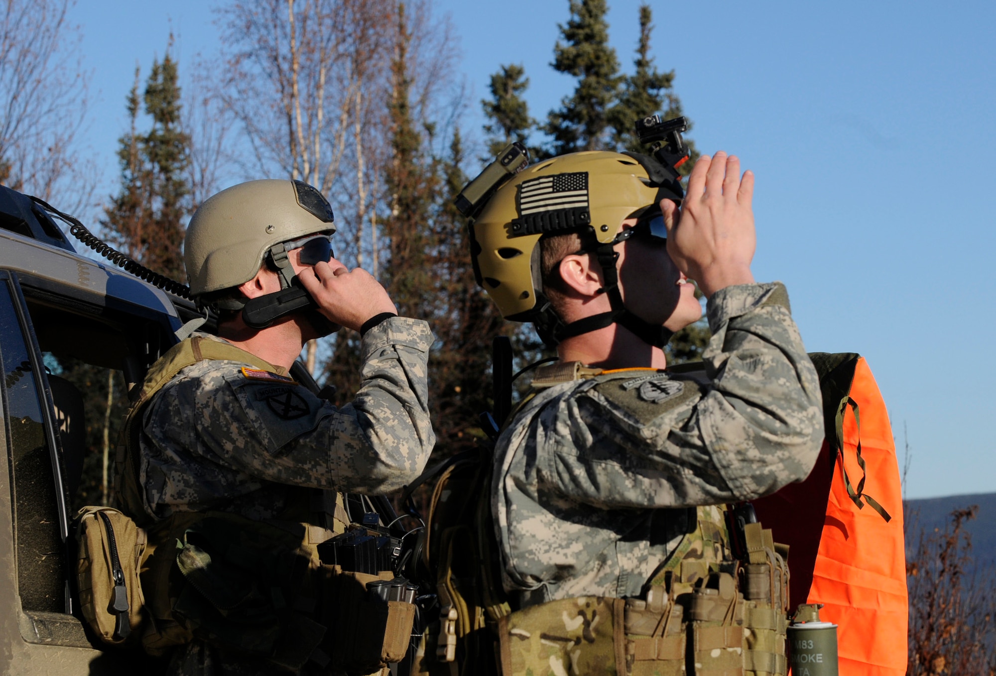 U.S. Army Capt. Houston Sheets makes radio contact with a pilot while  Staff Sgt. Sean Hogan makes visual contact of aircraft for close-air-support missions  during RED FLAG- Alaska 10-1 Oct. 12, 2009 Eielson Air Force Base, Alaska. The soldiers coordinate, request, and control close-air support giving pilots in the air a better visual of a target. Both are assigned to the Operation Detachment Alpha, 326, 3rd Battalion, 1st Special Forces Group Airborne, Fort Lewis, Wash. (U.S. Air Force photo/Airman 1st Class Laura Goodgame)