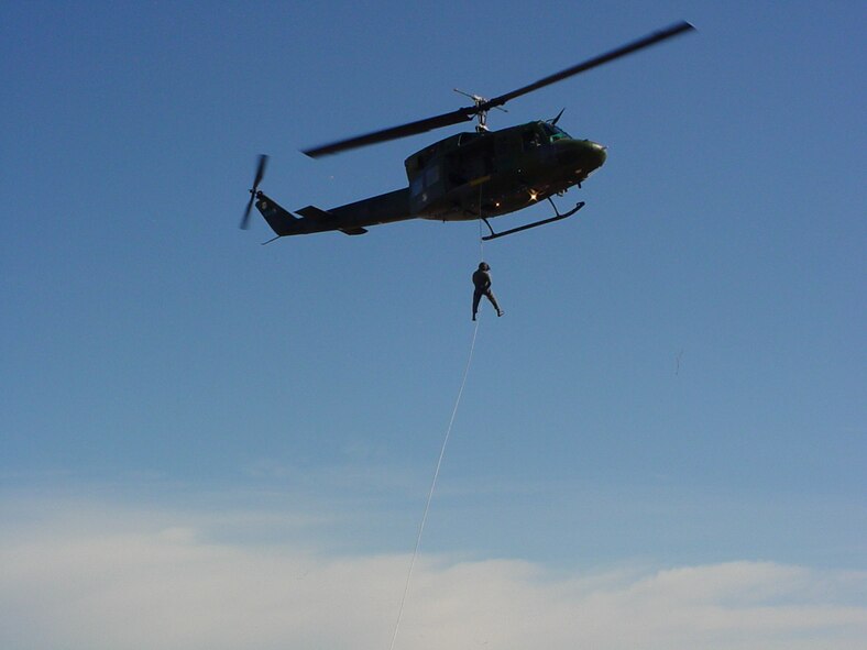 An independent medical technician with the 36th Rescue Flight here rappels from a U-H1N Huey helicopter. (US Air Force photo/ Staff Sgt. Jacob Bragg)