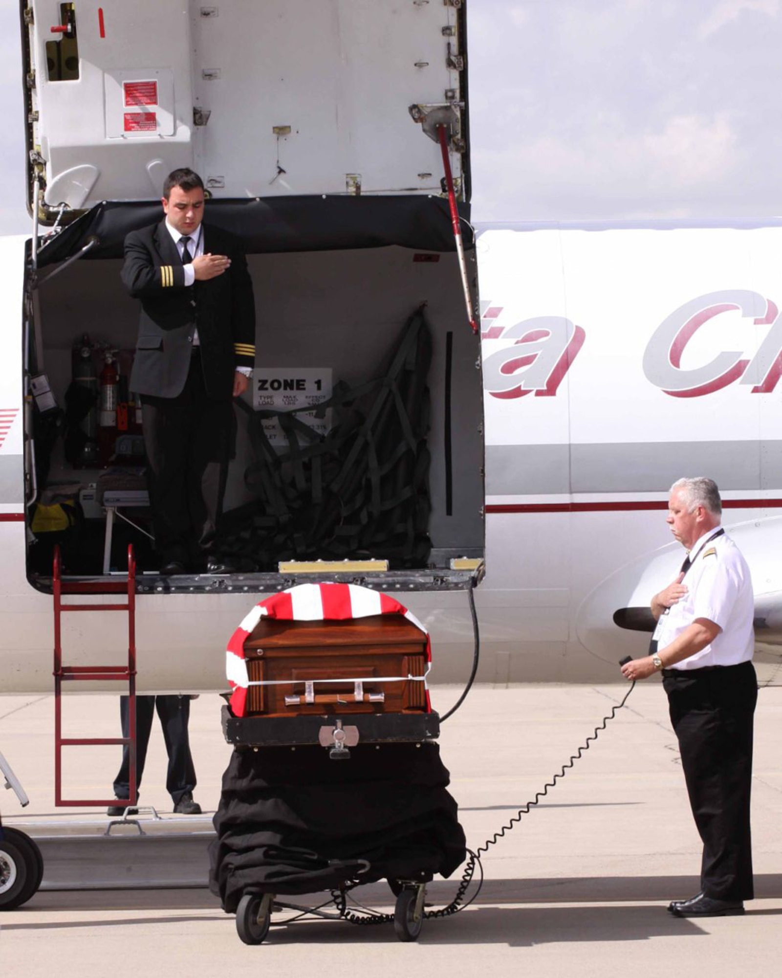 Aircrew members who flew Arizona Army National Guard Staff Sgt. Thomas Rabjohn home pay their respects after lowering his casket onto the Luke Air Force Base flight line Oct. 12. (Phoenix PD/Courtesy Photo)