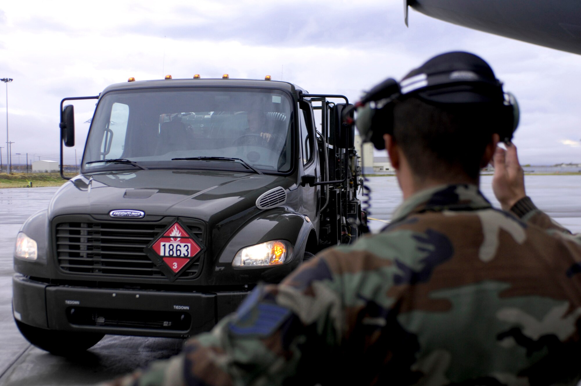 ELMENDORF AIR FORCE BASE, Alaska -- Staff Sgt. Casey Hall, 517th Aircraft Maintenance Unit, directs a fuel truck so that members of the 517th AMU can refuel a C-17 Globemaster III Oct. 8 during Red Flag-Alaska 10-01. Red Flag-Alaska is a Pacific Air Forces directed field training exercise for U.S. forces, flown under simulated air combat conditions. It is conducted on the Joint Pacific Alaskan Range Complex with air operations flown out of Eielson and Elmendorf Air Force bases. (U.S. Air Force photo/Airman 1st Class Christopher Gross)