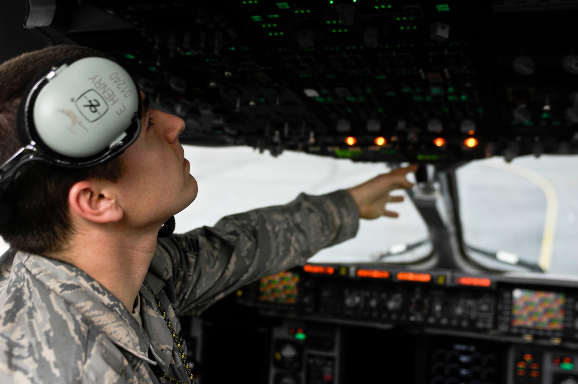 ELMENDORF AIR FORCE BASE, Alaska -- Senior Airman Edward Henry, 517th Aircraft Maintenance Unit, checks the oil levels on a C-17 Globemaster III after landing Oct. 8 during Red Flag-Alaska 10-01. Red Flag-Alaska is a Pacific Air Forces directed field training exercise for U.S. forces, flown under simulated air combat conditions. It is conducted on the Joint Pacific Alaskan Range Complex with air operations flown out of Eielson and Elmendorf Air Force bases. (U.S. Air Force photo/Airman 1st Class Christopher Gross)
