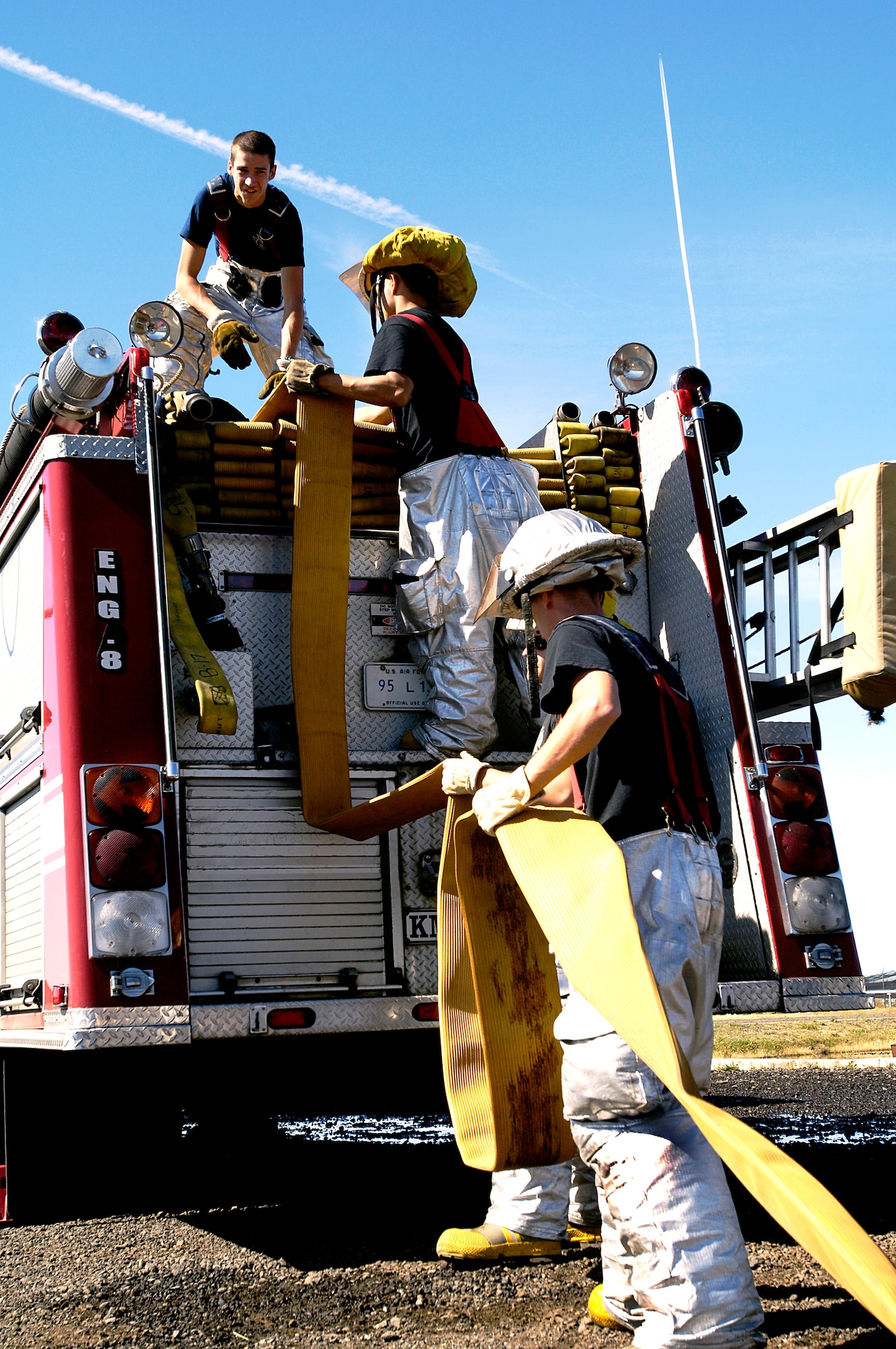 Fairchild Air Force Base fire fighters with the 92nd Civil Engineering Squadron load their equipment back onto the fire truck after a fire fighting training exercise here Sept. 10. (U.S. Air Force photo/ Airman 1st Class Natasha E. Stannard)