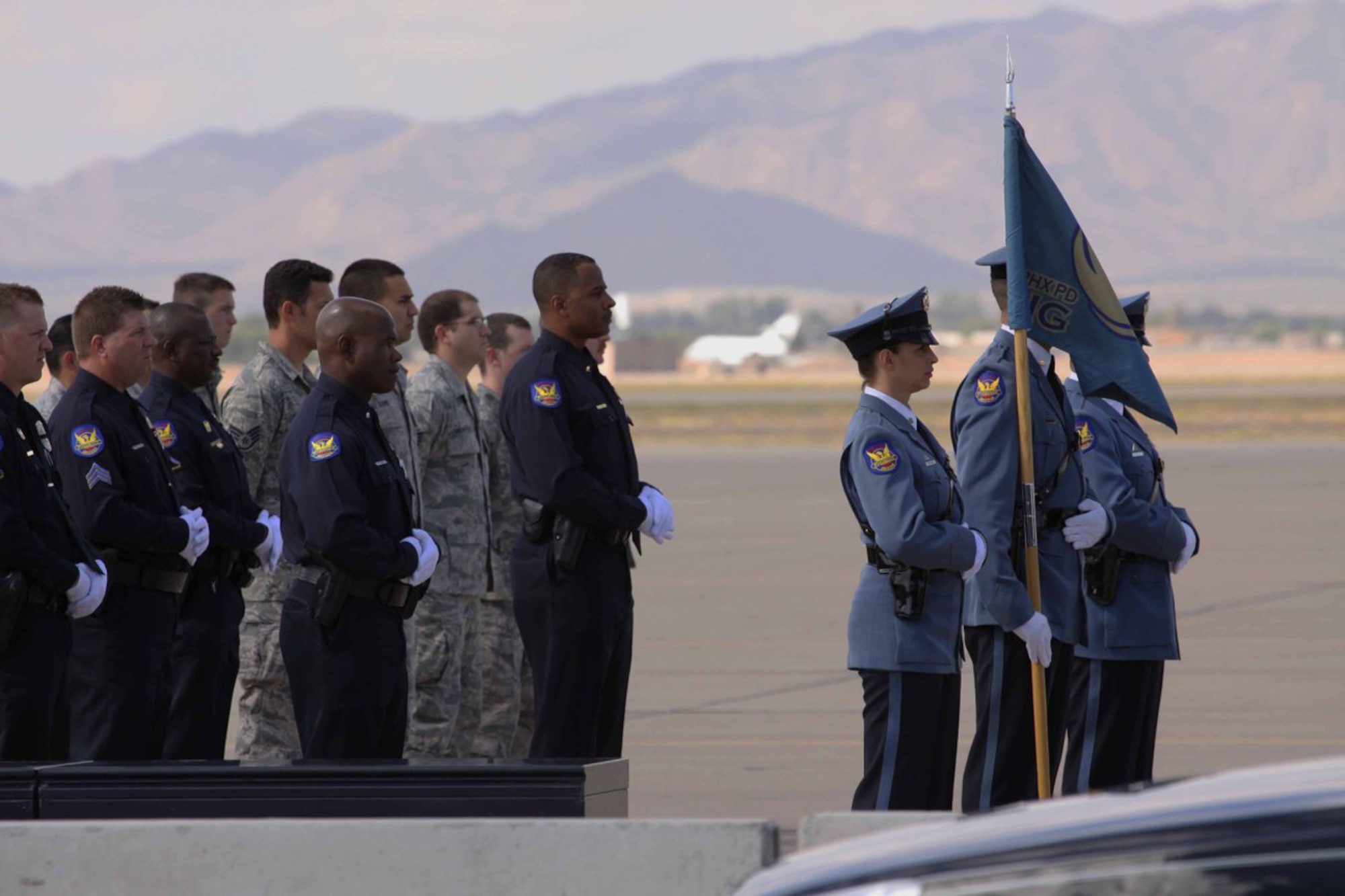 A formation of Phoenix police officers and Luke Air Force Base Airmen await the arrival of a commercial aircraft Oct. 12 bringing home Arizona Army National Guard Staff Sgt. Thomas Rabjohn after he was killed while serving as an explosive ordnance technician in Afghanistan.  Staff Sgt. Rabjohn was also a Phoenix police officer. (Phoenix PD/Courtesy photo)