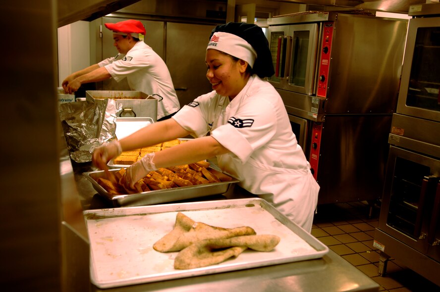 Airman 1st Class Isylma Edge, 92nd Force Support Squadron services chef, prepares garlic bread for lunch at the Warrior dining facility here Sept. 22.  Airman Edge works the morning shift at the dining facility in which she prepares breakfast, serves breakfast, and prepares and serves lunch. The morning shift begins at 4:30 a.m. and ends at 1:30 p.m. (U.S. Air Force photo/Airman 1st Class Natasha E. Stannard)