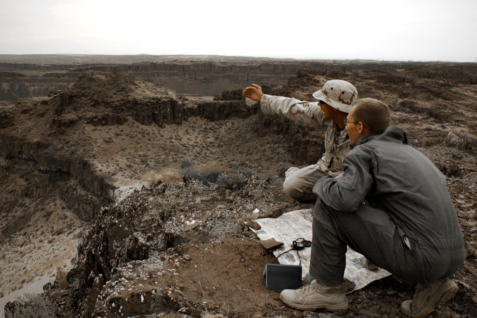 A 66th Training Squadron Survival, Evasion, Resistance, Escape specialist, explains proper triangulation technique during the desert survival training phase to a hopeful SERE candidate.  (U.S. Air Force photo / Senior Airman Joshua K. Chapman)