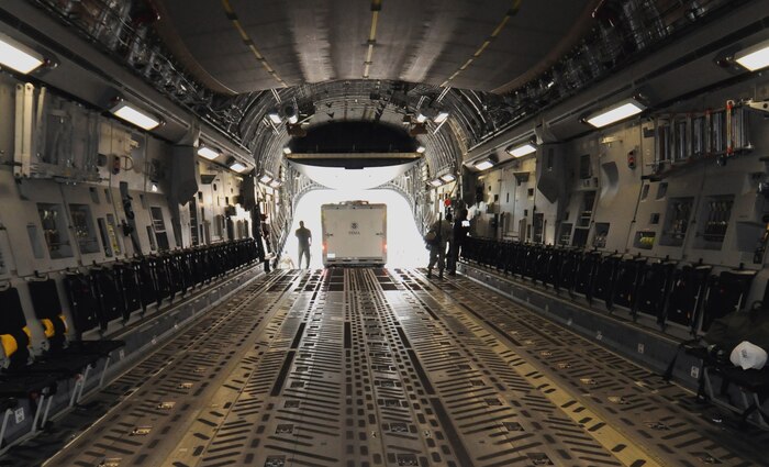 A portable Logistics Incident Command Base is loaded aboard a Charleston AFB C-17 at Dobbins AFB, Ga., Oct. 2. Two vehicles were transported to set up logistical assistance in response to the recent tsunami in American Samoa. The aircrew of the C-17 assisted FEMA in rapid deployment on short notice to respond to the disaster. (George Armstrong/FEMA)
