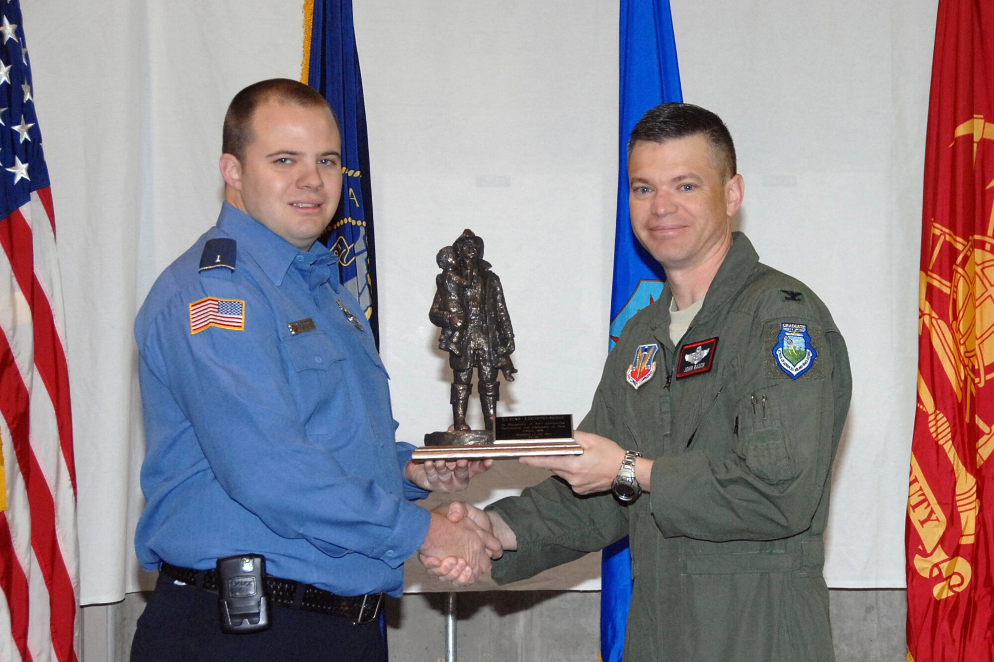 OFFUTT AIR FORCE BASE, Neb. --- Col. John T. Rauch, 55th Wing vice commander, presents the Firefighter of the Year Award to Lucas Lechtenberg, a firefighter with the 55th Civil Engineer Squadron, during a ceremony at the Offutt Fire House Oct. 9. U.S. Air Force Photo by Kendra Williams