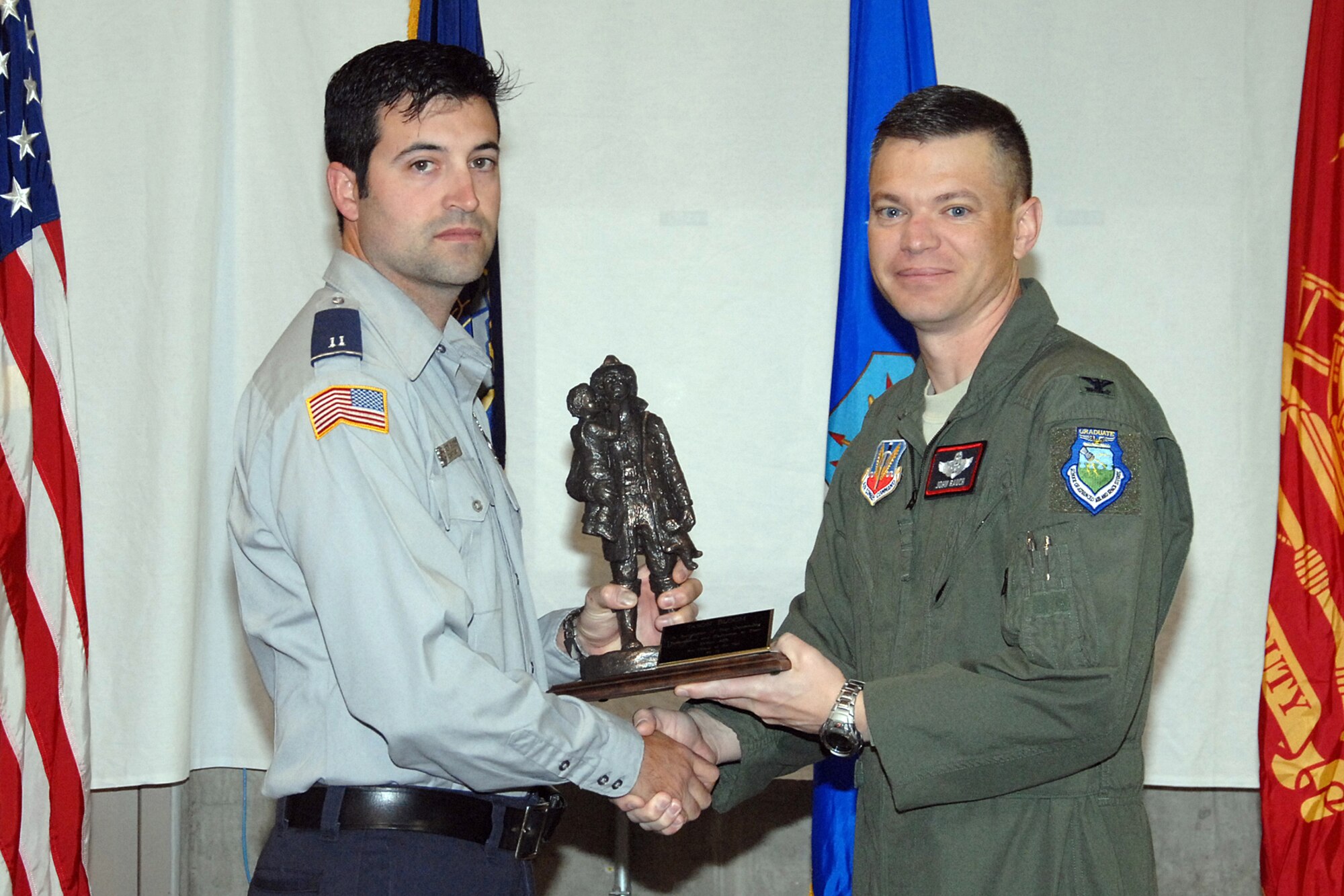 OFFUTT AIR FORCE BASE, Neb. --- Col. John T. Rauch, 55th Wing vice commander, presents the Fire Officer of the Year Award to Jason Bloom of the 55th Civil Engineer Squadron, during a ceremony at the Offutt Fire House Oct. 9. U.S. Air Force Photo by Kendra Williams