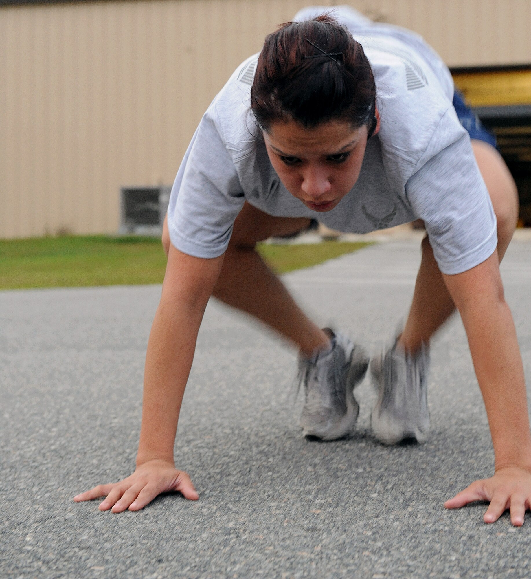 MOODY AIR FORCE BASE Ga. -- Staff Sgt. Christina Kaun, 820th Security Forces commander support squadron NCO in-charge, performs a squat thrust exercise during the Airman 1st Class Leebernard Chavis memorial workout here Oct. 14. Airman Chavis was assigned to the 820th SFG and was killed in action in 2006. (U.S. Air Force photo by Airman 1st Class Joshua Green)