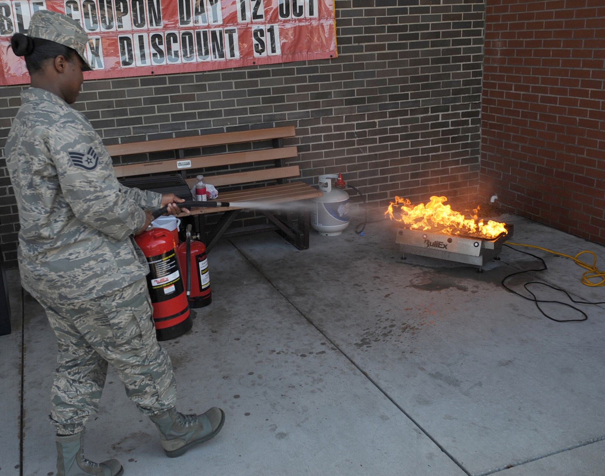 Staff Sgt. Courtney Dorsey, 4th Logistics Readiness Squadron customer support technician, exterminates a fire as part of Fire Prevention Week on Seymour Johnson Air Force Base, N.C., Oct. 9, 2009. Fire Prevention Week is held annually to commemorate the Great Chicago Fire of 1871, and increase fire safety, awareness and education. (U.S. Air Force photo/Senior Airman Ciara Wymbs)