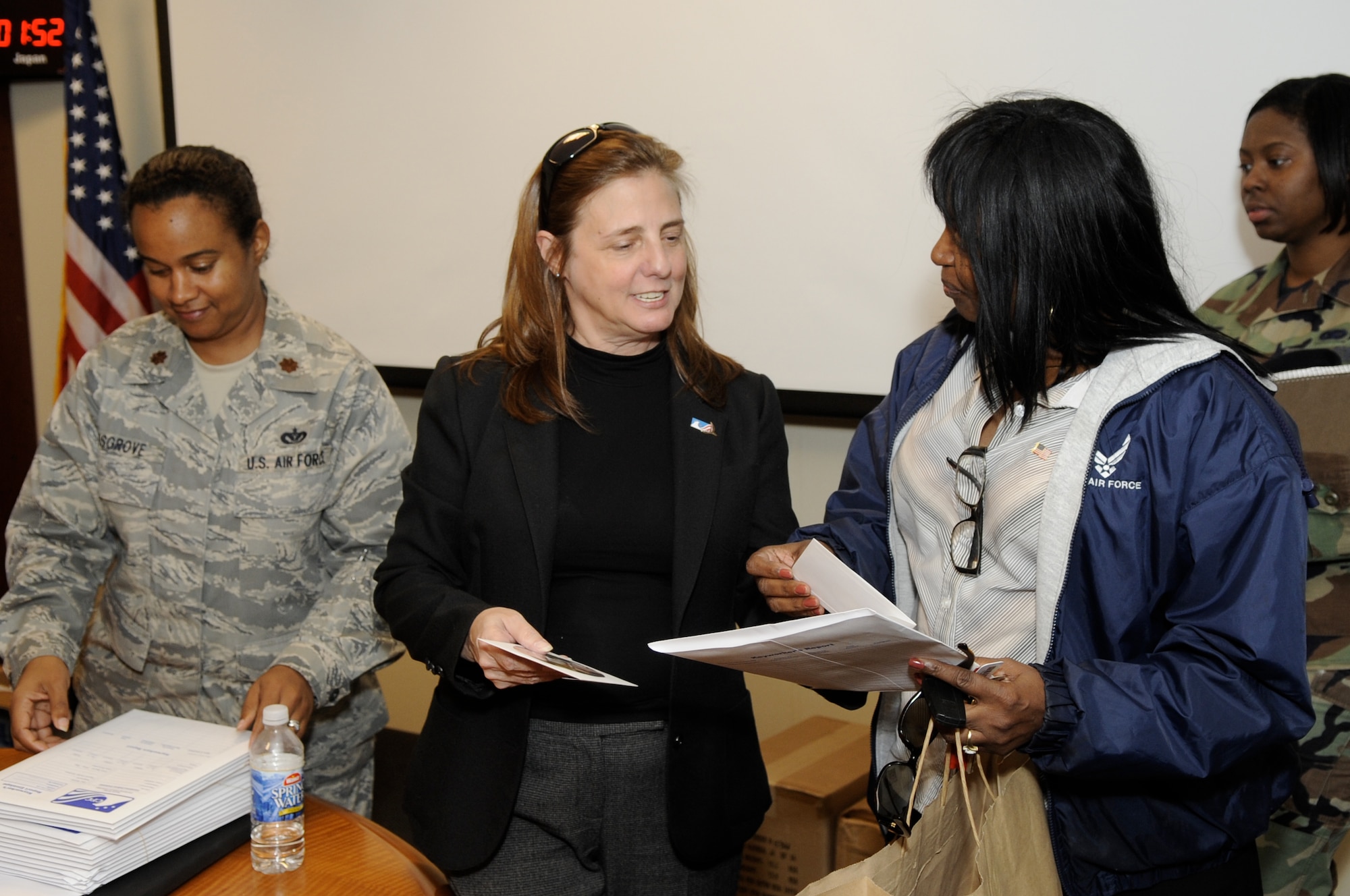 Maj. Karen Cosgrove, Joint Base McGuire-Dix-Lakehurst  Combined Federal Campaign point of contact, and Valerie Scott, CFC representative from United Way,  hand out training materials to JB MDL campaign key workers. More than 50 representatives from throughout JB MDL assembled Oct. 8 to receive training on taking the lead for the 2009 CFC challenge. (U.S. Air Force photo/Carlos Cintron)