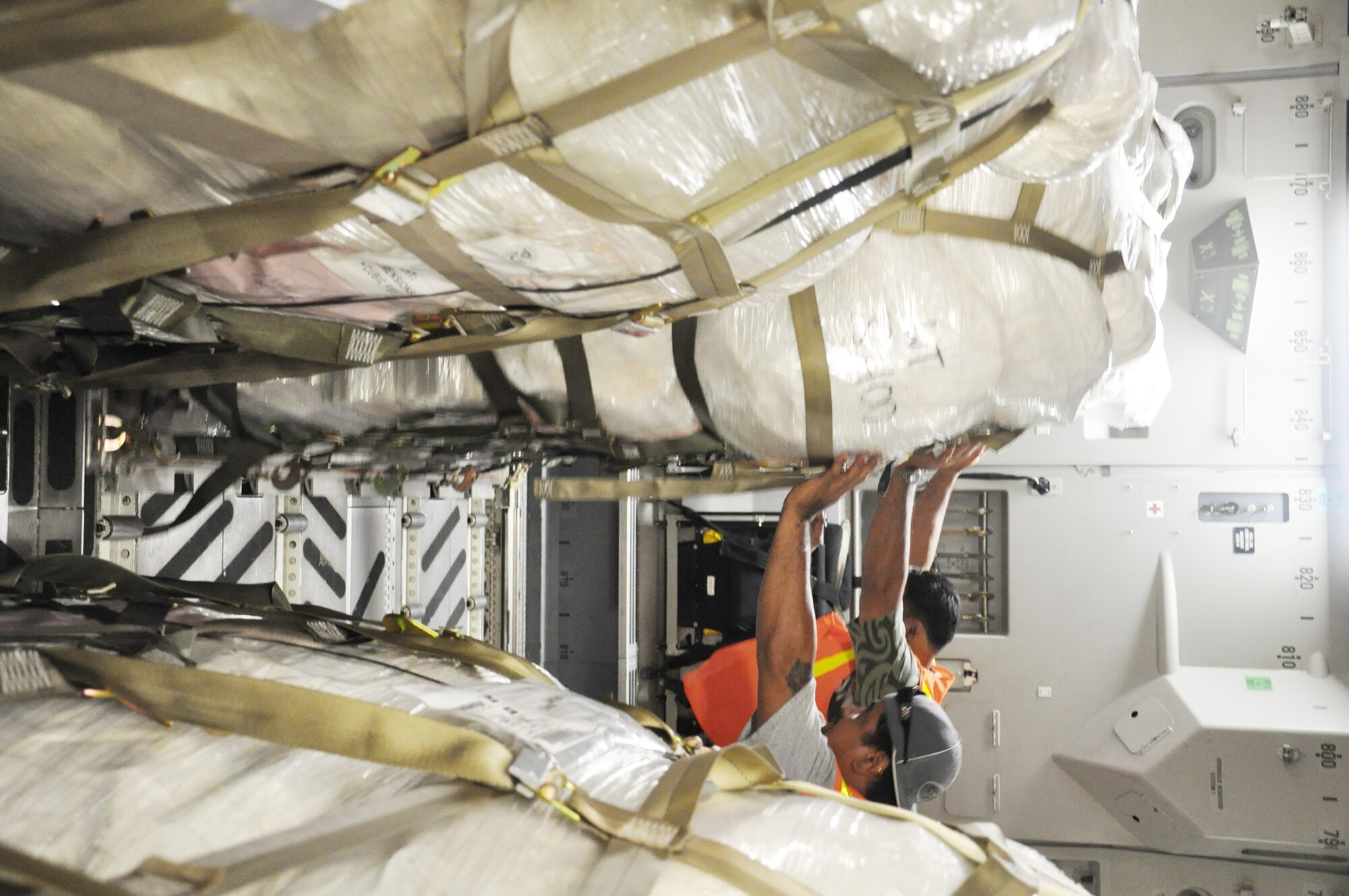 Airmen from McChord Air Force Base, Wash., and Hickam AFB, Hawaii, and Air Mobility Command civilians offload Federal Emergency Management Agency cargo from a C-17 Globemaster III Oct. 10, 2009, at Pago Pago International Airport, American Samoa. (U.S. Air Force photo/Staff Sgt. Eric Burks) 