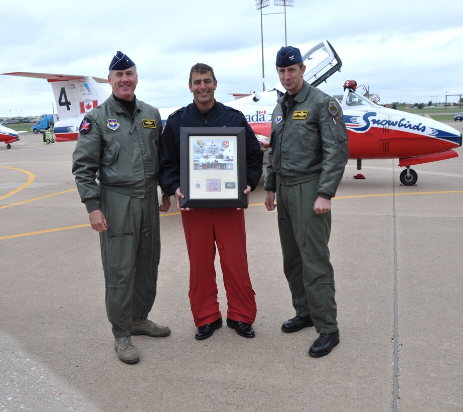 Brig. Gen. O.G. Mannon, 82nd Training Wing commander, and Col. Kevin Schneider, 80th Flying Training Wing commander, present Commanding Officer and Team Lead Maj. Chris Bard with a plaque as a “thank you” to the Canadian Snowbirds for their stunning performance at Sheppard’s 2009 Open House and Air Show Oct. 10-11. (U.S. Air Force Photo/ Airman 1st Class Adawn Kelsey)
