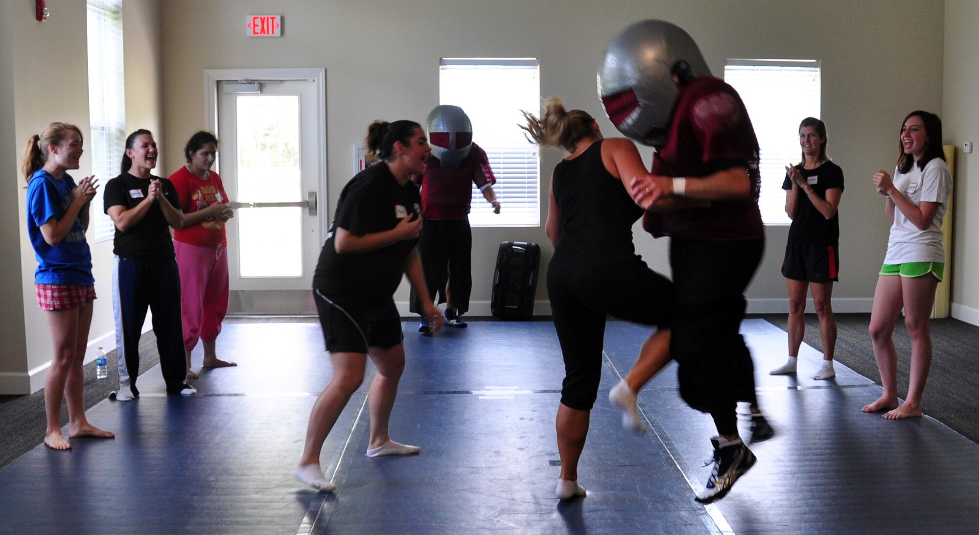 Jodie Auteri, wife of Col. Gino Auteri, 325th Medical Group Commander, practices self defense on a Bullet Man Suit worn by Major David Boyd, 325th Security Forces Squadron Commander. (U.S. Air Force photo by Airman 1st Class Rachelle Elsea)
	

