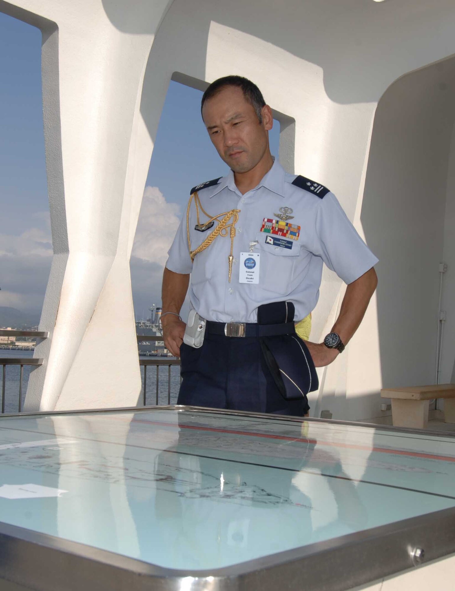 PEARL HARBOR, Hawaii -- Japan Air Attaché Colonel Yoshinori Ozaki pauses for a moment of reflection at the U.S.S. Arizona memorial here which honors those who lost their lives during the 1941 attacks by Japan on the United States. Thirty-seven Air Attachés and their spouses - 78 people total from 32 countries - visited Hawaii during a Chief of Staff-directed annual tour Oct. 4-10. These Attachés, who are representatives of international air forces at the Pentagon in Washington, D.C., get distinguished treatment in the Pacific and Europe during these visits to the theaters of operations for the U.S. Air Force. It is important for the U.S. Air Force to demonstrate its ability to fly, fight and win as well as extend hospitality to allied military forces. While here, the Attachés also visited Pacific Command, Pacific Air Forces, and Joint POW/MIA Accounting Command and laid a wreath at the U.S.S. Arizona memorial. (U.S. Air Force photo/Vanessa Forlione)
