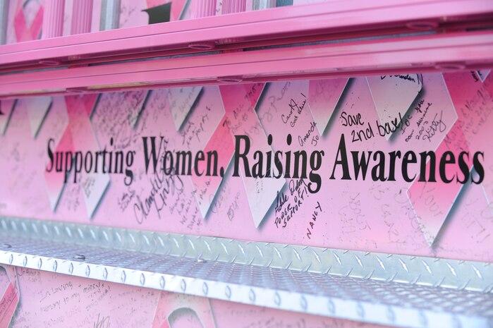 "Supporting Women, Raising Awareness" is the Pink Heals Tour motto. The Pink Heals Tour stopped at Charleston AFB Oct. 9 with its caravan of pink fire trucks before making its way across the country and audience members were allowed a chance to sign the trucks. (U.S. Air Force photo/Senior Airman Amber Grimm)