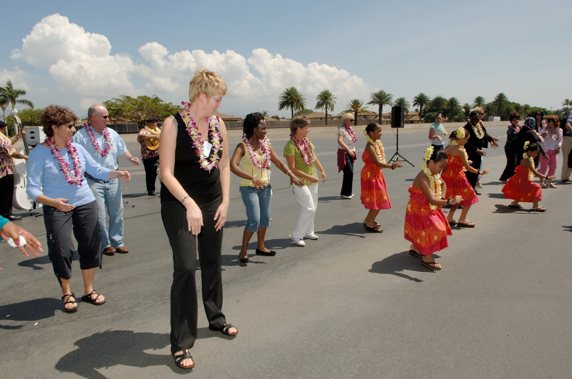 HICKAM AIR FORCE BASE, Hawaii -- Thirty-seven Air Attachés and their spouses - 78
people total from 32 countries - learn the hula on the flightline here during a Chief of Staff-directed annual tour Oct. 4-10. These Attachés, who are representatives of international air forces at the Pentagon in Washington, D.C., get distinguished treatment in the Pacific and Europe during these visits to the theaters of operations for the U.S. Air Force. It is important for the U.S. Air Force to demonstrate its ability to fly, fight and win as well as extend hospitality to allied military forces. While here, the Attachés visited Pacific Command, Pacific Air Forces, and Joint POW/MIA Accounting Command and laid a wreath at the U.S.S. Arizona memorial at here in honor of those who lost their lives during the 1941 attacks on the United States. (U.S. Air Force photo/Mark Bates)
