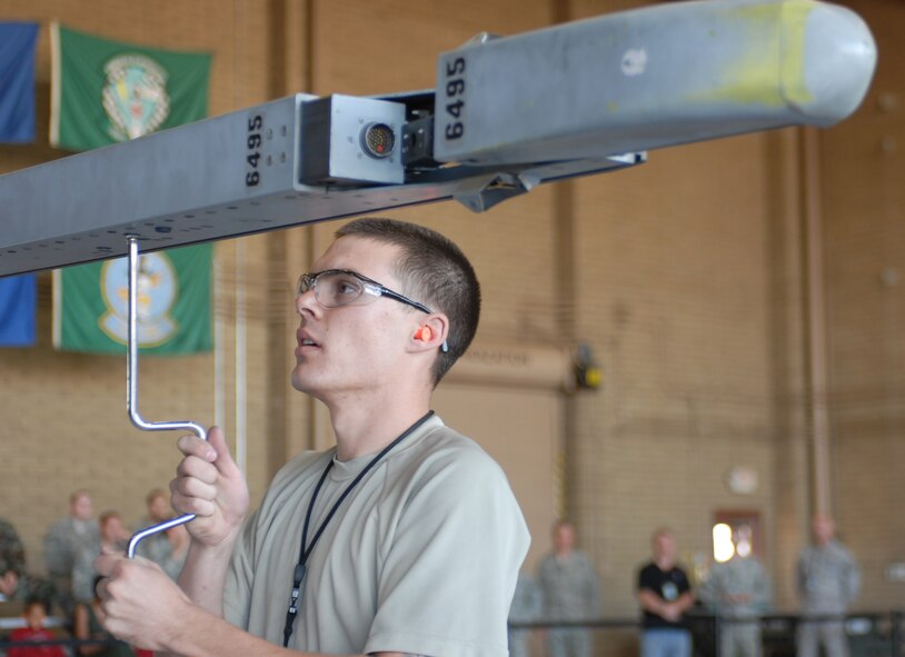 Senior Airman Dustin Jones, 61st Aircraft Maintenance Unit weapons load crew member, preps a F-16 to attach an AIM 120 missile during the Quarterly Weapons Load Crew Competition at Luke Air Force Base, October 9, 2009. (U.S. Air Force photo by Airman 1st Class Sandra Welch)