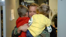 MINOT AIR FORCE BASE, N.D. -- Master Sgt. Frank Cowper, 5th Aircraft Maintenance Squadron production manager, embraces his children upon his return here Feb. 23 from Andersen AFB, Guam. Deployments can be hard, which is one reason why the Air Force is focusing on the importance of family this year. (U.S. Air Force photo by Airman 1st Class Benjamin Stratton)