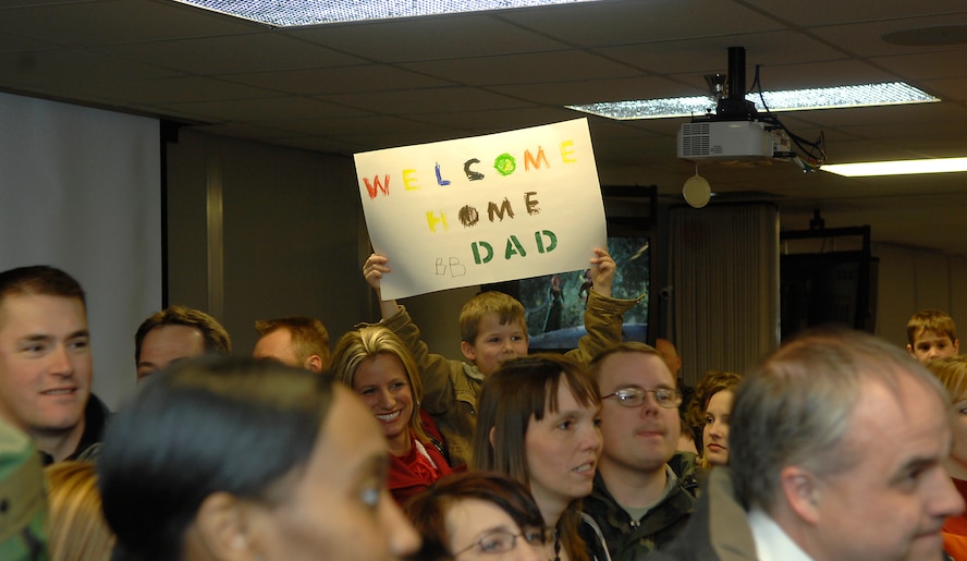 MINOT AIR FORCE BASE, N.D. -- A little boy holds his sign high as he patiently awaits his father’s return here Feb. 23 from Andersen AFB, Guam at dock nine. Deployments can be hard, which is one reason why the Air Force is focusing on the importance of family this year. (U.S. Air Force photo by Airman 1st Class Benjamin Stratton)