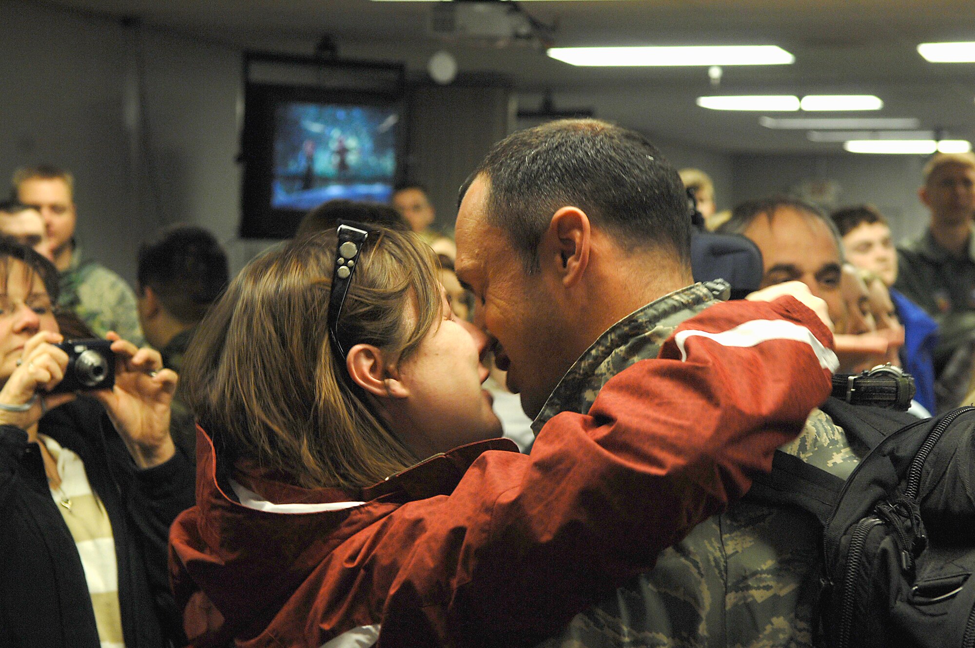 MINOT AIR FORCE BASE, N.D. -- A wife kisses her husband upon his return here Feb. 23 from Andersen AFB, Guam. Deployments can be hard, which is one reason why the Air Force is focusing on the importance of family this year. (U.S. Air Force photo by Airman 1st Class Benjamin Stratton)