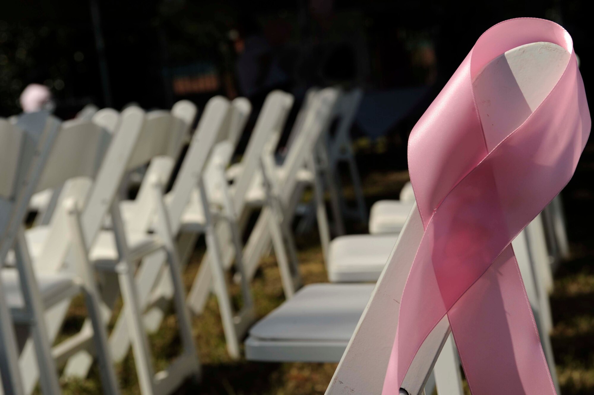 A pink ribbon decorates audience seating during the set up of the Pink Heals Tour here Oct. 9. The 437th Medical Group invited Team Charleston to attend the event in support of all women in their fight against cancer. (U.S. Air Force photo/Senior Airman Amber Grimm)