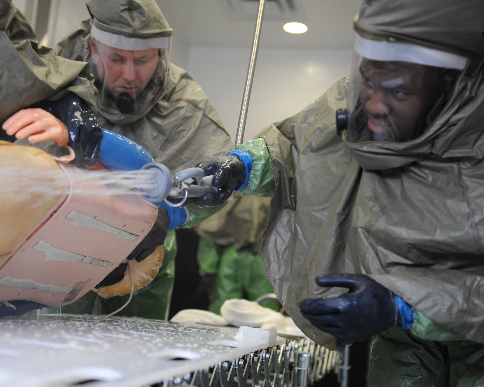 WHITEMAN AIR FORCE BASE, Mo. – Airman 1st Class Marcus Dudley, 509th Medical Operatiosn Squadron, sprays water on the back of a mannequin during training, Oct. 13. The purpose of the training is to minimize the loss of operational capability caused by biological-related wartime contingencies and provide maximum protection for base personnel. (U.S. Air Force photo/Senior Airman Cory Todd)