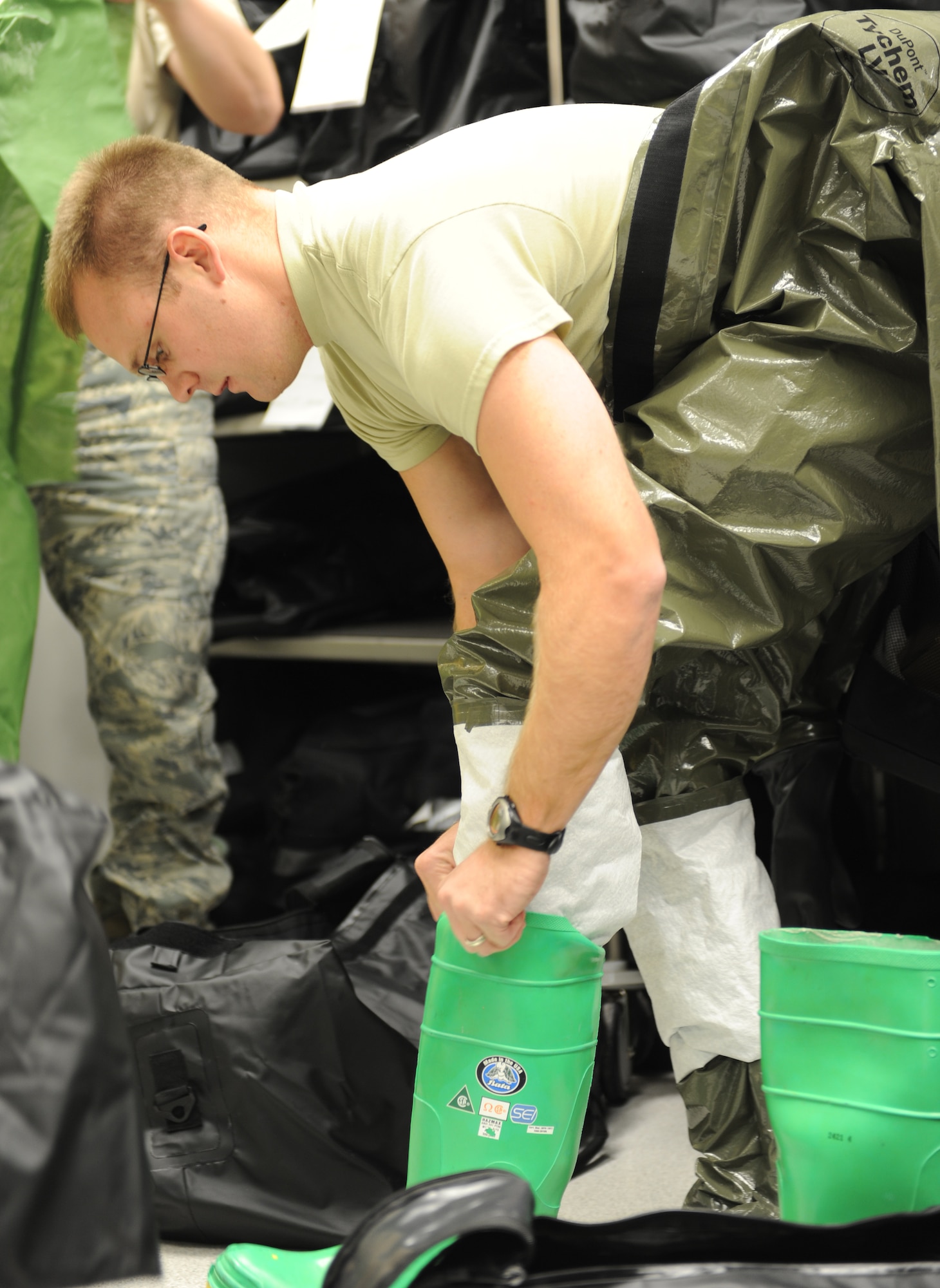 WHITEMAN AIR FORCE BASE, Mo. – Staff Sgt. Cory Philp, 509th Medical Operations Squadron, puts on the boot of the disposable toxicological agent system suit, Oct. 13. The purpose of the training is to minimize the loss of operational capability caused by biological-related wartime contingencies and provide maximum protection for base personnel. (U.S. Air Force photo/Senior Airman Cory Todd)