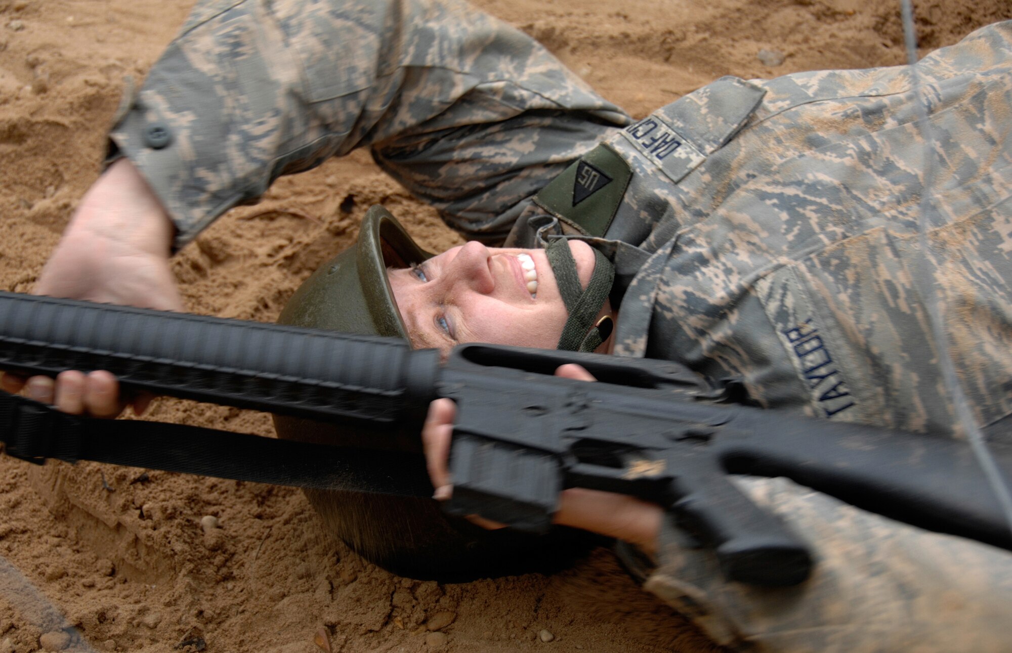 Mrs. Judith Taylor, 59th Medical Wing historian, learns combat skills during medical readiness training Mar. 24 at Camp Bramble, Lackland Air Force Base, Texas.  Department of Defense employees are required to accomplish the same training as military as they prepare to deploy. (U.S. Air Force photo by Master Sgt. Kimberly Yearyean-Siers)