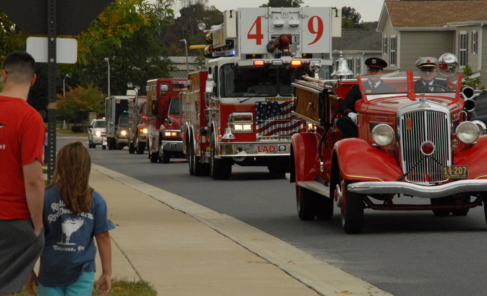 Base housing residents watch as equipment from the Dover Air Force Base Fire Station and off base agencies parade through Eagle Heights to conclude Fire Prevention Week Oct. 10. (U.S. Air Force photo by Staff Sgt. Chad Padgett)