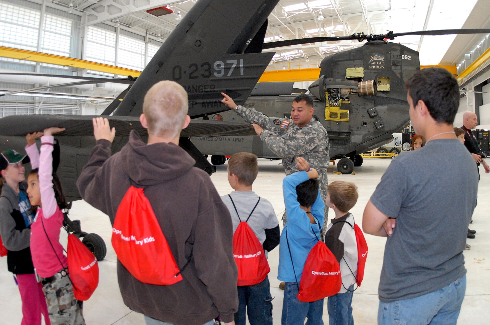 Army 1st Lt. Bryant Ronald, Helicopter Pilot, explains how the military uses helicopters during the Buckley Air Force Base Youth Mock Deployment, Oct 3.  This event was held to help children understand what their parents see and experience during a deployment. (U.S. Air Force photo by Tech. Sgt. J. LaVoie)