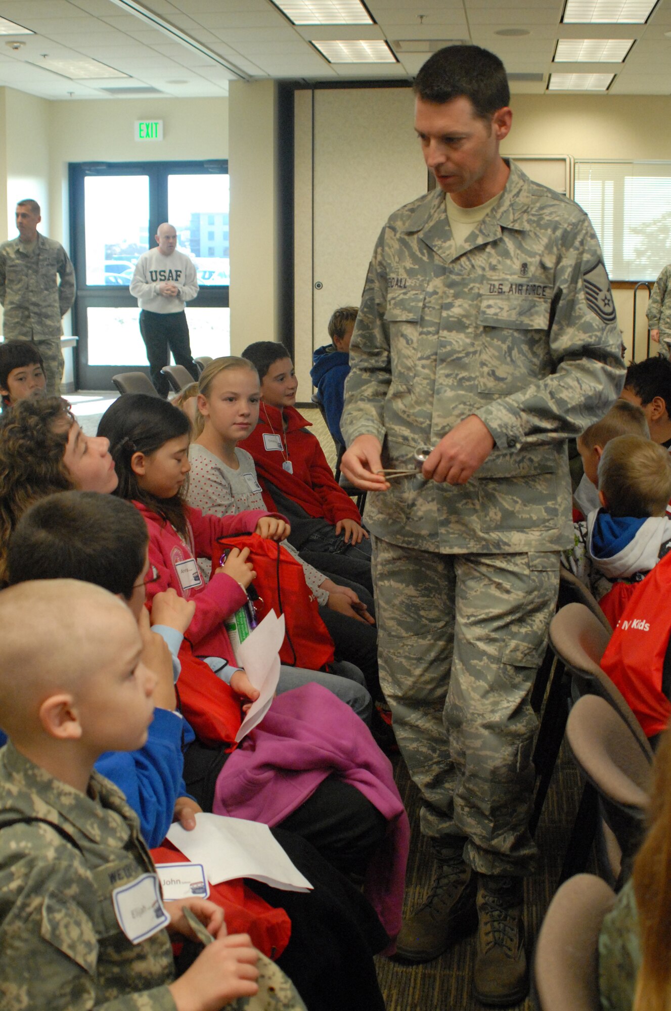 Master Sgt. Joseph Siddall, 460th Medical Operations Squadron, a volunteer troop commander briefs his chalk during the Buckley Air Force Base Youth Mock Deployment, Oct 3.  Youths started the day with a deployment briefing in the base chapel. (U.S. Air Force photo by Tech. Sgt. J. LaVoie)