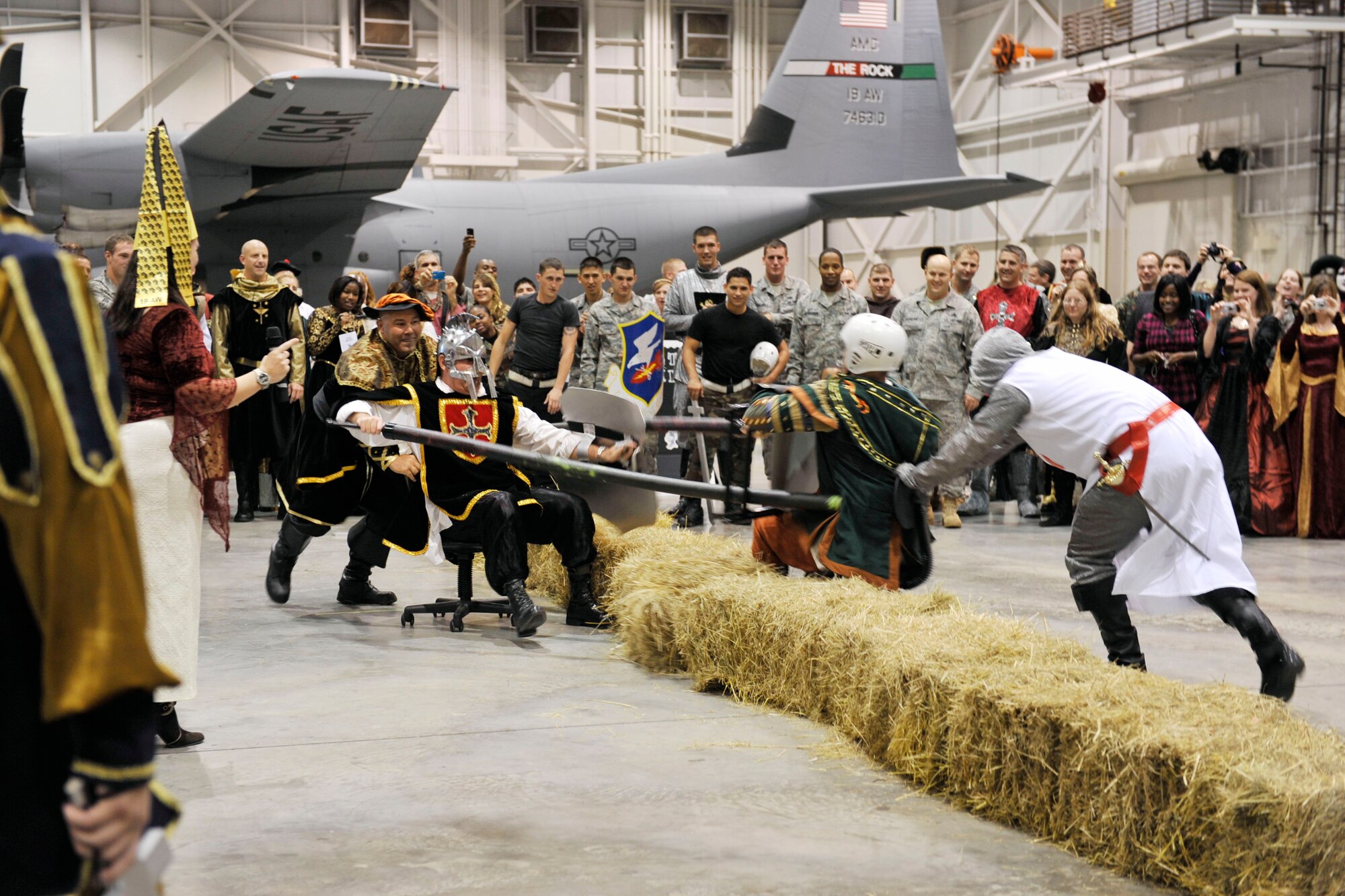 Col. Chris Hair, 19th Maintenance Group commander and Chief Kevin Inskeep, 19th MXG superintendent, compete in a jousting tournament against Col. David Kasberg, 19th Operations Group commander and a member of the 19 OG during the Black Knight Heritage Dinner on base Oct. 9. The dinner celebrated the 19th Airlift Wing’s rich history as the Air Force’s premier C-130 airlift wing. (U.S. Air Force photo by Airman Lausanne Pacheco)