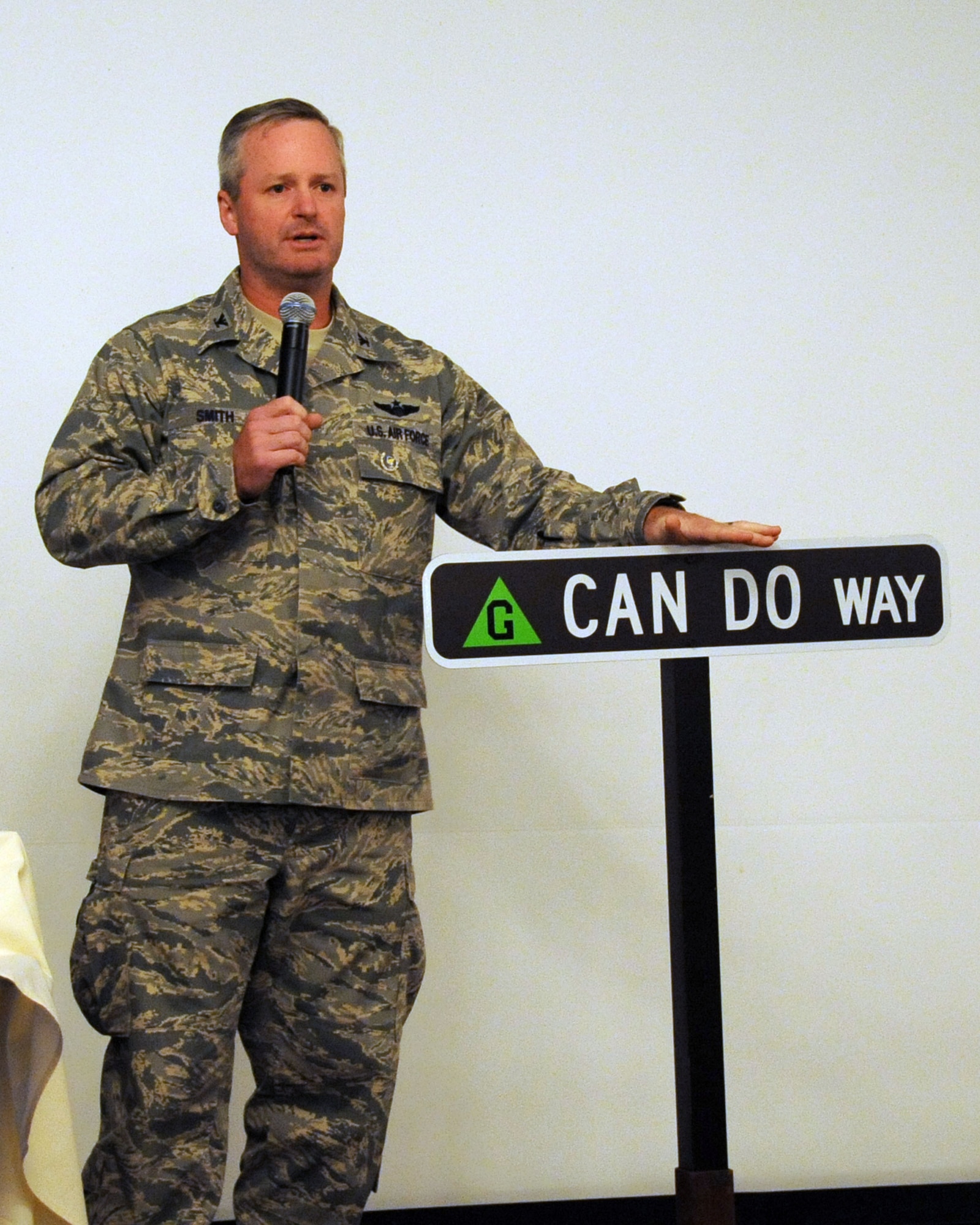 Col. Scott Smith, 305th Air Mobility Wing commander, speaks to a crowd during the unveiling of a new street sign here Oct. 8. The new street name, "Can Do Way," is a tribute to the original 305th Bomber Group whose motto was "Can Do." Surviving members of the 305th BG held a reunion here and in the local area Oct. 7 through 11. Though the name of the unit has evolved, the motto still stands today. (U.S. Air Force photo/ Angel Lopez)
