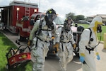 Zach McCabe (left), and Senior Airman Tyler McClain, 12thFire and Emergency Services fire fighters, escort Senior Airman Kathleen Smith, 12th Medical Group Bioenviromental section, into the scene of a real world chlorine leak at Randolph Air Force Base Oct. 8.  (U.S. Air Force photo by Rich McFadden) 