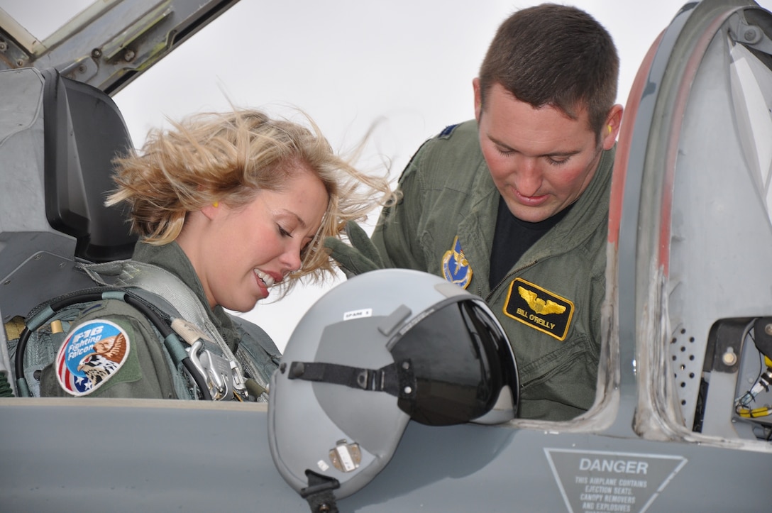 Capt. Bill O’Reilly, an 80th Operations Group T-38 flight examiner, ensures his wife, Jocelyn O’Reilly, an 82nd Force Support Squadron marketing assistant, is properly secured before their ride on Spouse Taxi Day Oct. 9. Attendees were taxied around in their spouses’ aircraft. (U.S. Air Force photo/Airman 1st Class Valerie Hosea)