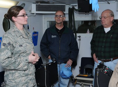 Senior Airman Bethany King, an aerospace physiology technician with the 12th Aeromedical Dental Squadron, talks to civilian pilots about the altitude chamber during the Civil Fly-In Oct. 10. Nearly 60 local aviators attended the event to learn about flying operations of the 12th Flying Training Wing and participate in the information exchange. In addition to flying safety briefings and presentations by the Federal Aviation Administration, the Civil Fly In featured displays from life support, security forces, the base fire department, and aerospace physiology. Randolph's assigned T-1, T-6, T-38, and T-43 were also on static display for the civilian aviators to tour. (U.S. Air Force photo/Don Lindsey) 
