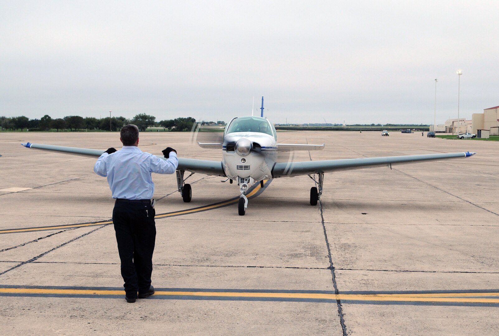 Shane Musselman, Randolph crew chief, directs a Civil Air Patrol plane to a parking spot at the Civil Fly In here Oct. 8. ( U.S. Air Force Photo By Don Lindsey)