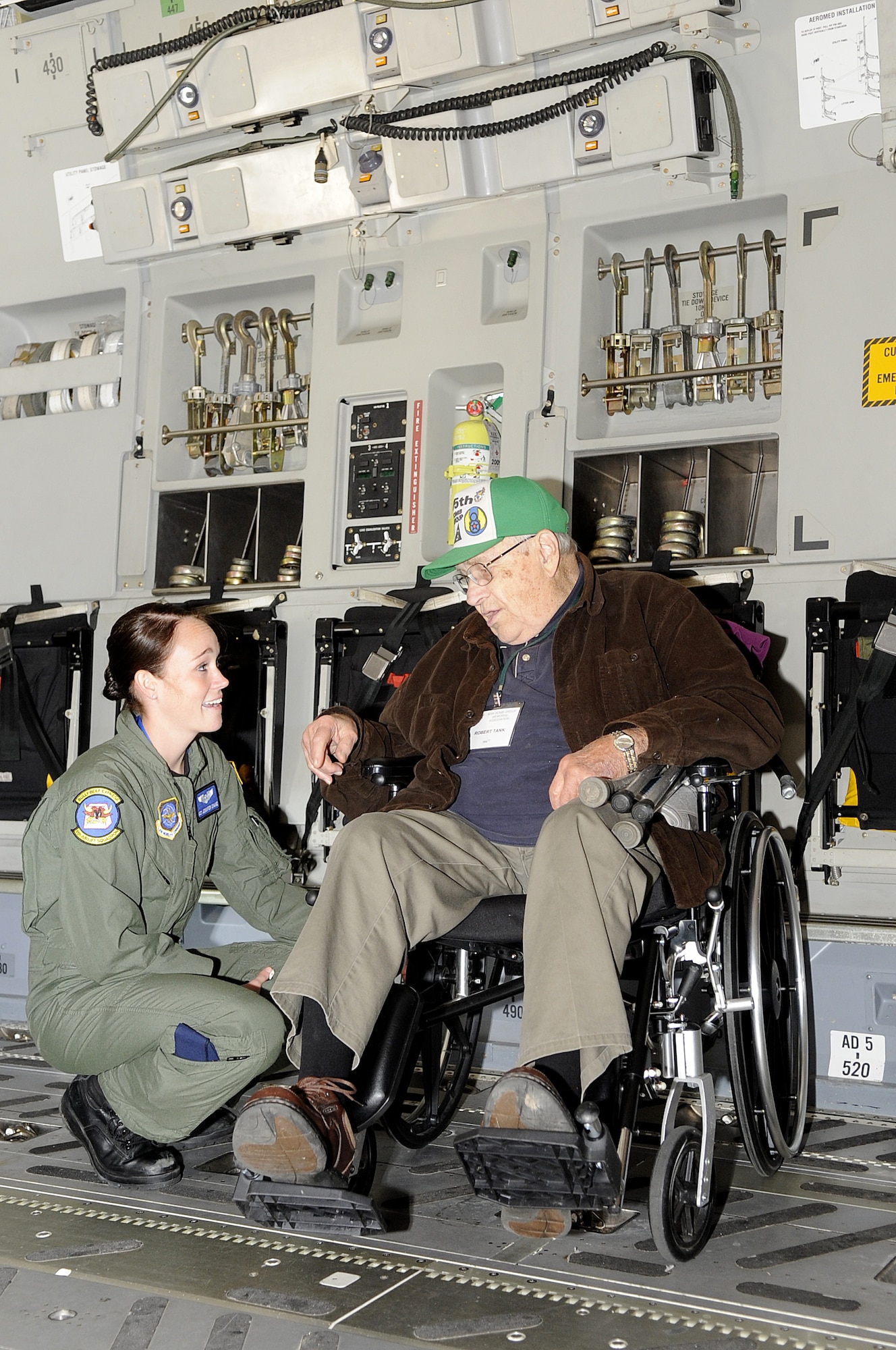 During a C-17 tour here, Airman 1st Class Jennifer Drane, 6th Airlift Squadron, listens to Robert H. Tank, 305th Bomb Group, as he recounts some of his experiences during World War II.  Members of the 305th Bomb Group Memorial Association attended a memorial service at the basecChapel and a luncheon at the community center as part of their 2009 reunion activities.
(U.S. Air Force photo/Carlos Cintron)
