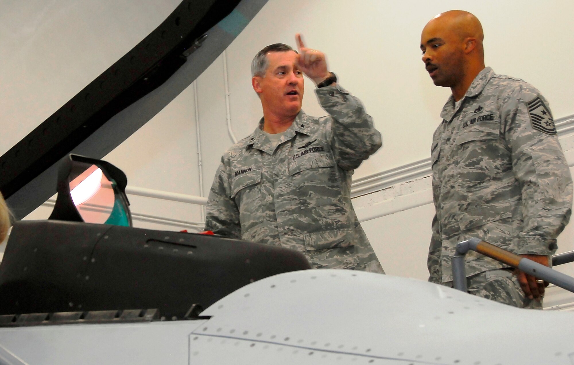 Brig. Gen. O.G. Mannon, 82nd Training Wing commander, explains the functions of an F-22 simulator to Chief Master Sgt. Linus Jordan, the new 2nd Air Force command chief, Oct. 6 during his visit to Sheppard. (U.S. Air Force photo/ Harry Tonemah)