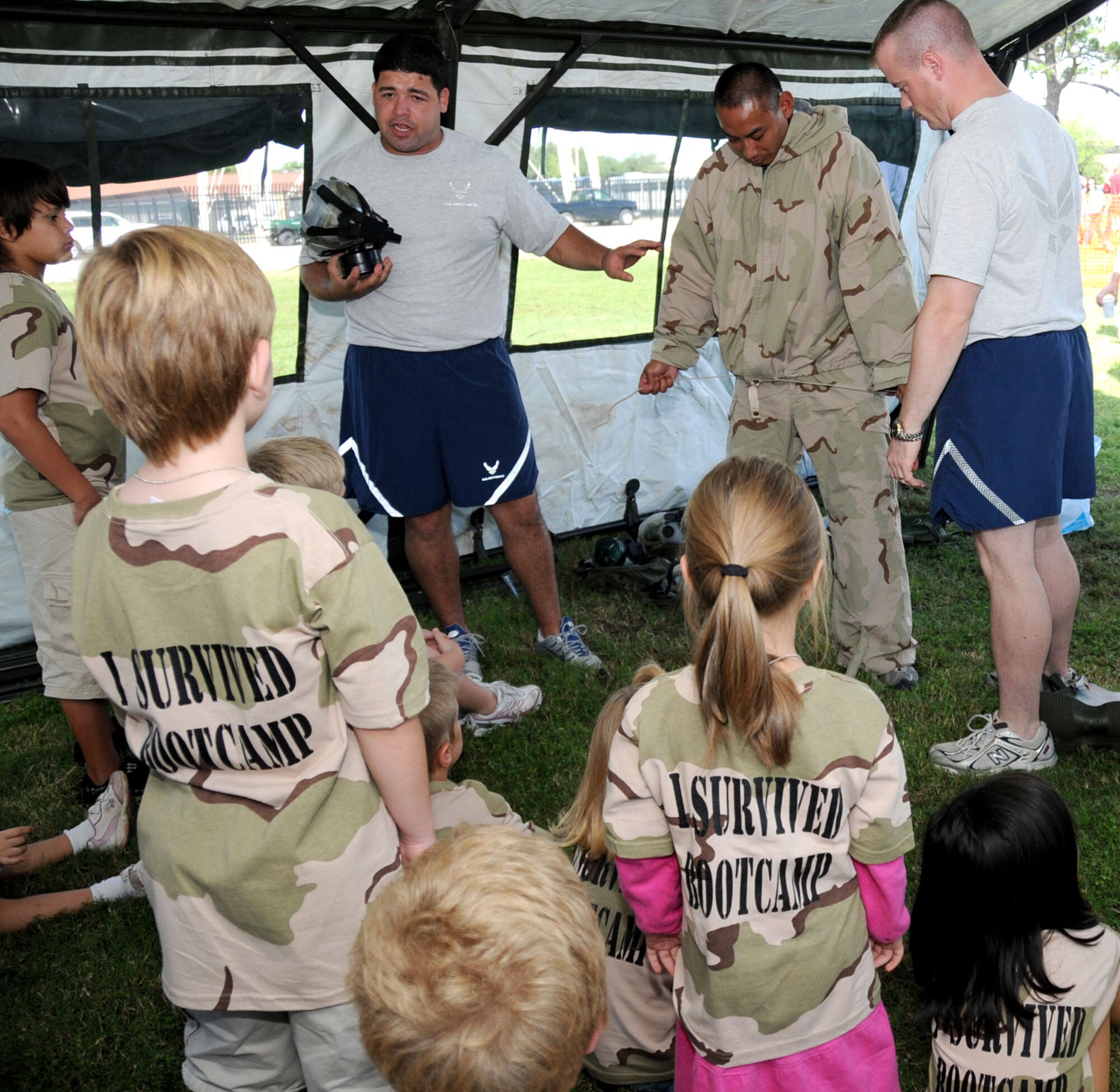 From left, Senior Airmen Ramon Nazario, 81st SFS; Steven Fuerrero, 81st Medical Operations Squadron; and Shawn Rykken, 338th Training Squadron, show Operation Hero participants how mission-oriented protective posture gear is worn and used.  (U.S. Air Force photo by Kemberly Groue)