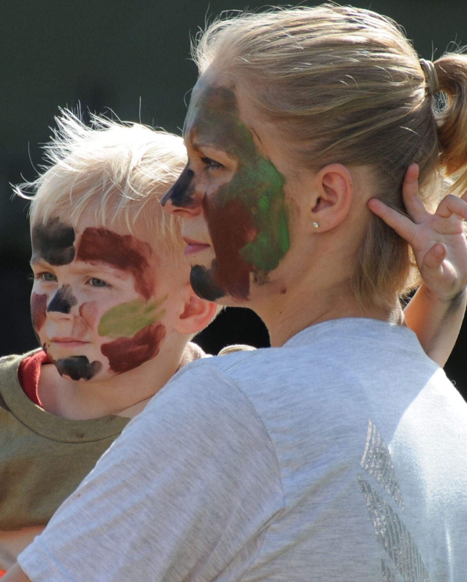 Brandon Hollars, 3½, and his mom, Senior Airman Crystal Hollars watch the military working dog demonstration.  Airman Hollars is assigned to the 81st Force Support Squadron.  (U.S. Air Force photo by Kemberly Groue)