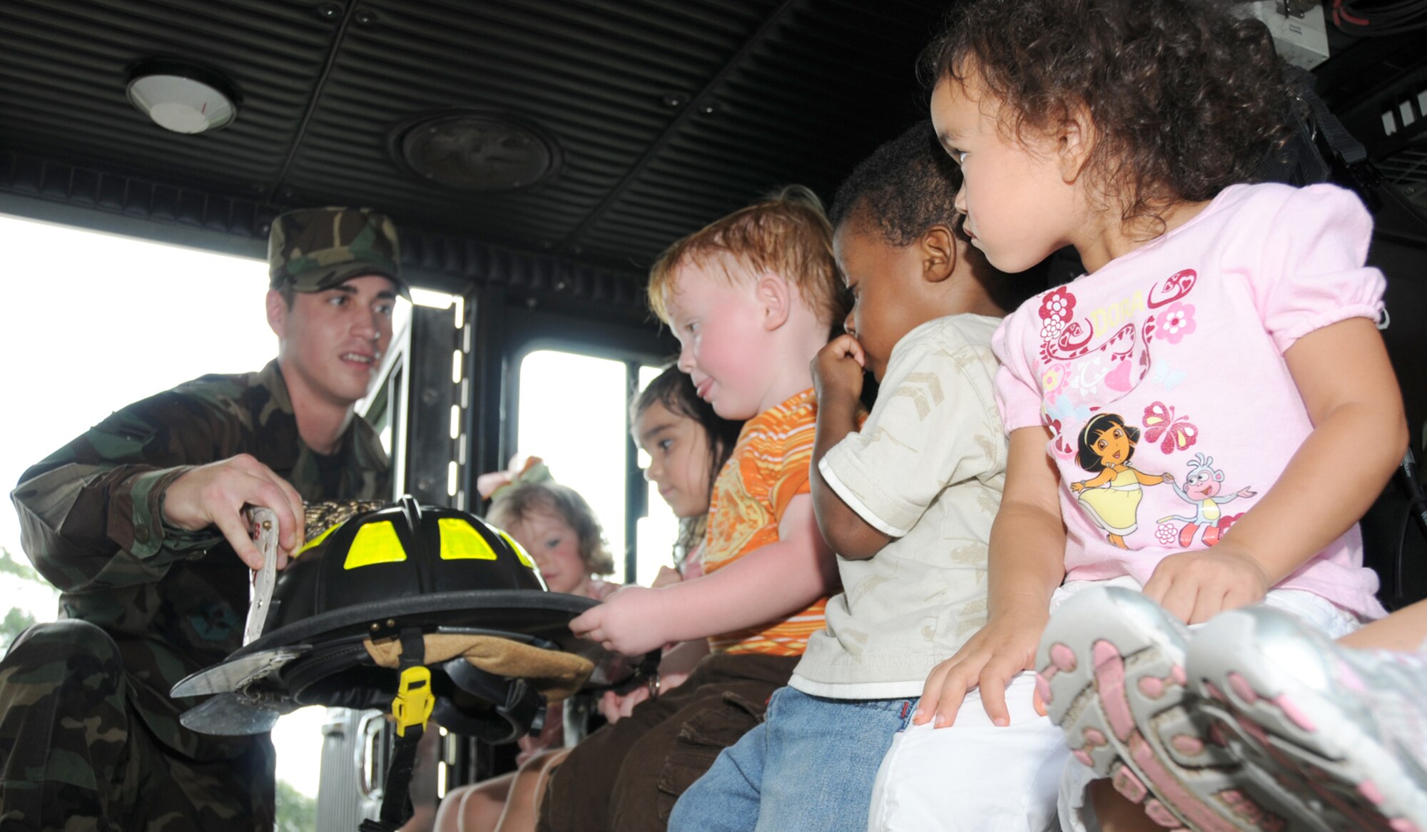 Airman 1st Class Nick Fasola from the fire department gives a tour of a fire truck to 2-year-olds from the child development center Oct. 6.  From left, the children are MacKenzie Townsend, daughter of Airman 1st Class Austin and Devann Townsend, 2nd Air Force; Sienna Escajeda, daughter of Senior Airman Rebecca and Alonzo Escajeda, 81st Dental Squadron; Chase Rash, son of Senior Master Sgts. Sherrieann Baldwin-Rash, 81st Comptroller Squadron, and Christopher Rash, 81st Security Forces Squadron; Micah Palmer, son of Tech. Sgt. Marcus and Tondra Palmer, 338th Training Squadron; and Braeylanna Rawaekklang, daughter of Staff Sgt. Naronksuk and Louanna Rawaekklang, 81st Diagnostics and Therapeutics Squadron. (U.S. Air Force photo by Kemberly Groue)