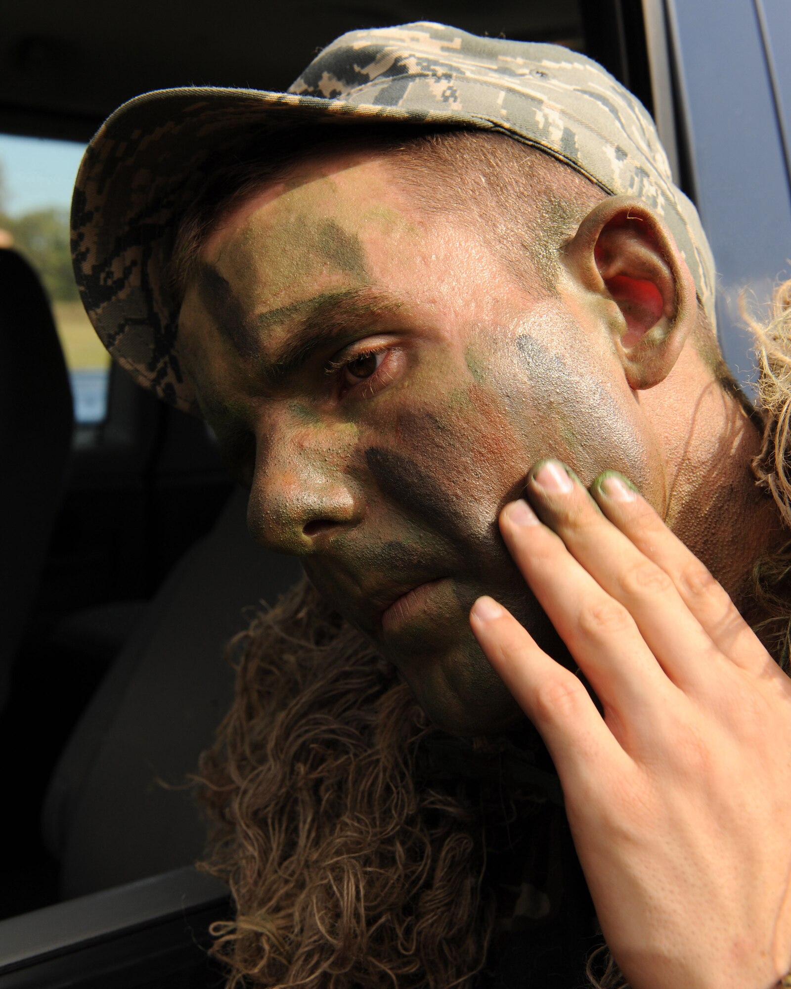Staff Sgt. Carl Hook, 19th Security Forces Squadron sharp shooter, applies camouflage paint to his face Oct. 8 as he prepares to practice stalking through the woods of Camp Robinson.  Staff Sgt. Hook recently received training in the Close Precision Engagement Course on Camp Robinson and is now training for the Inter-Service Sniper Sustainment Training Exercise held at Fort Chaffee, Ark. (U.S. Air Force photo by Staff Sgt. Chad Chisholm)