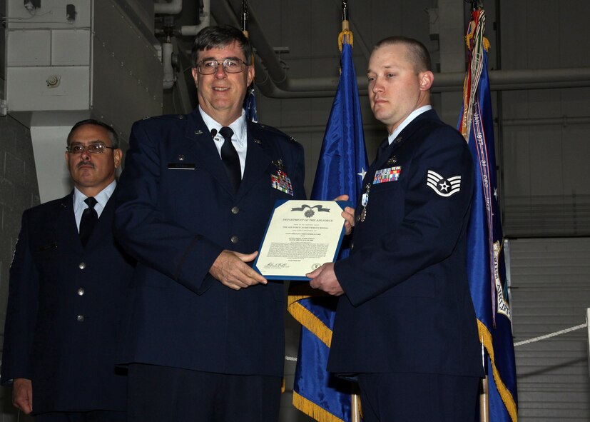 Staff Sgt. Christopher Card, 911th Communications Squadron, receives the Air Force Achievement Medal during Commander's Call held here Oct. 4, 2009.  Sergeant Card was awarded the medal for his quick and instinctive response when he witnessed a car accident on June 24, 2009.  Sergeant Card took control of the situation, rendered help to the injured and redirected traffic flow until authorities arrived.