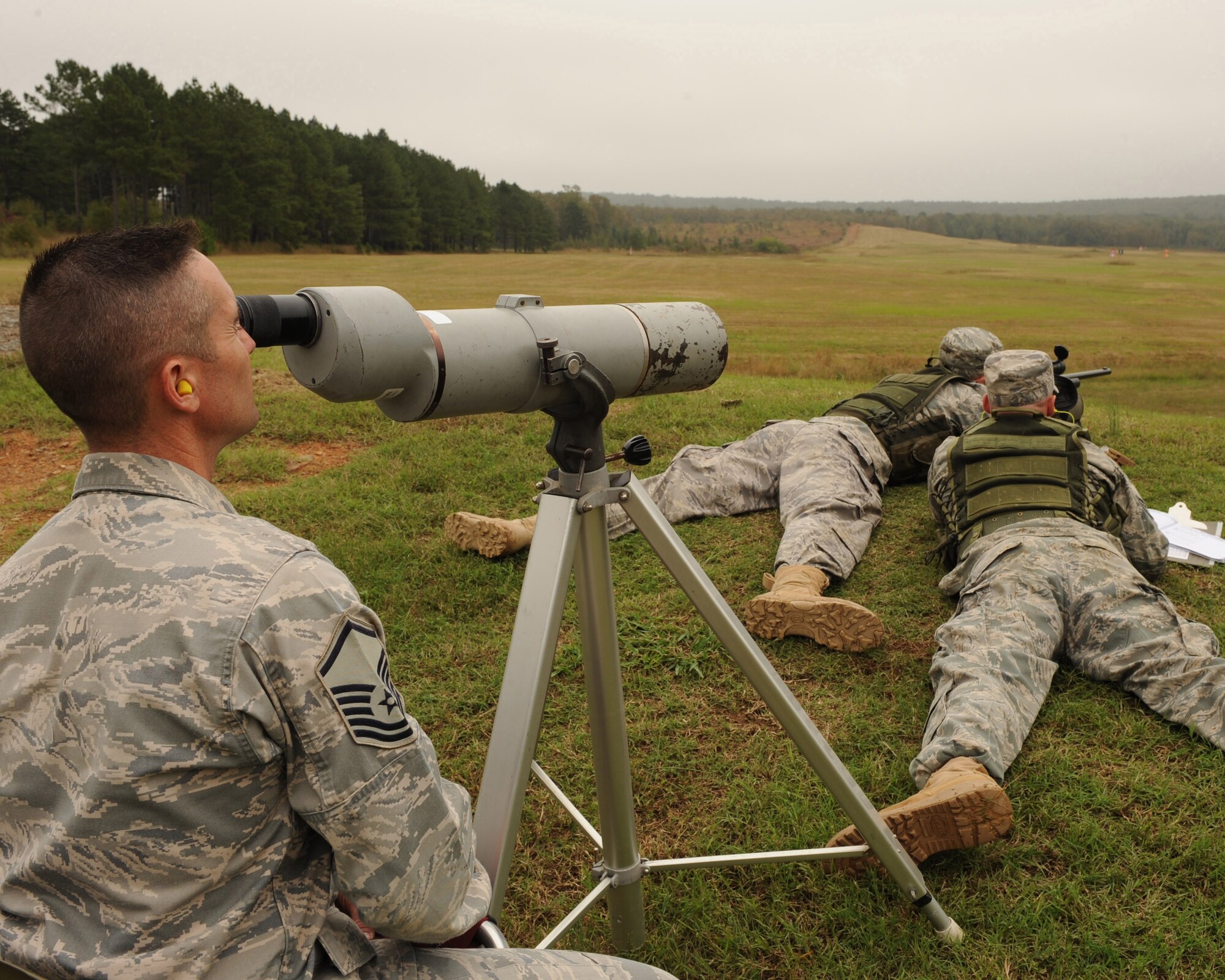 Master Sgt. Ron White, 188th Security Forces Squadron close precision engagement/advanced designated marksman course NCO-in-charge from Fort Smith, Ark., observes the vapor trail and impact of a shot taken by Staff Sgt. Carl Hook and Senior Airman Dane Coppini, 19th Security Forces Squadron sharp shooters, during a training session for the Inter-Service Sniper Sustainment Training Exercise at Fort Chaffee, Ark. (U.S. Air Force photo by Staff Sgt. Chad Chisholm)