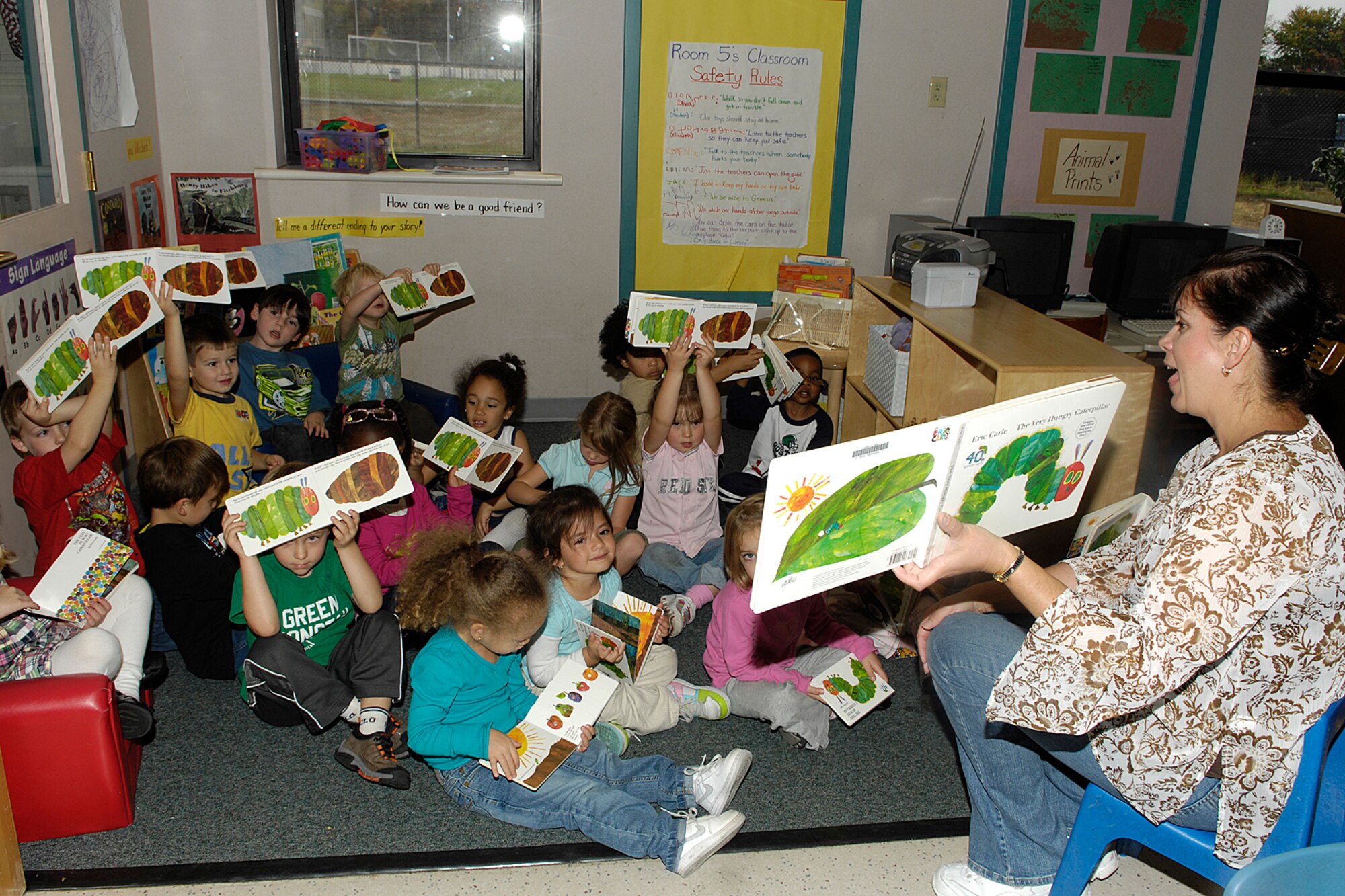 HANSCOM AIR FORCE BASE, Mass. – Eve Peabody, 66th Force Support Squadron, reads to children in Room 5 at the Child Development Center on Oct. 8, as part of Jumpstart’s national Read for the Record Campaign. The campaign is designed to bring attention to the importance of early education by encouraging hundreds of thousands of children and adults to read the same book on the same day. USO New England donated copies of the book, The Hungry Caterpillar, to children enrolled in the CDC’s pre-school program as part of the Read for the Record campaign. (U.S. Air Force photo by Linda LaBonte Britt)